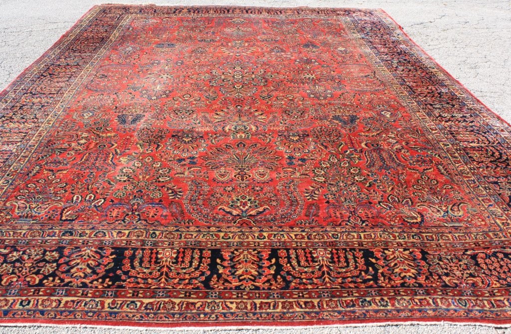 CA 1920 ROOM SIZE PERSIAN SAROUK, RED FIELD WITH: OVERALL FLORAL AND URN DESIGN. SEVERAL MINOR AREAS OF WEAR AS SEEN IN PHOTOS. 16' 8 1/2" X 11' 8".