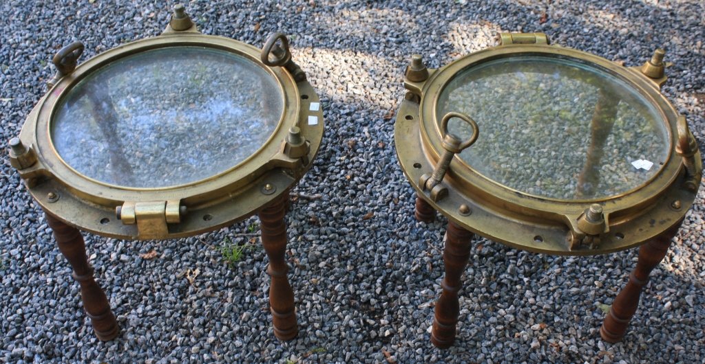 MATCHED PAIR OF 20TH C BRONZE PORTHOLE TABLES: MARKED WOJIDKOW, SWEDEN AND ENCAST SECURITGLAS. 16 1/2" HIGH X 21" DEEP. 52 POUNDS.