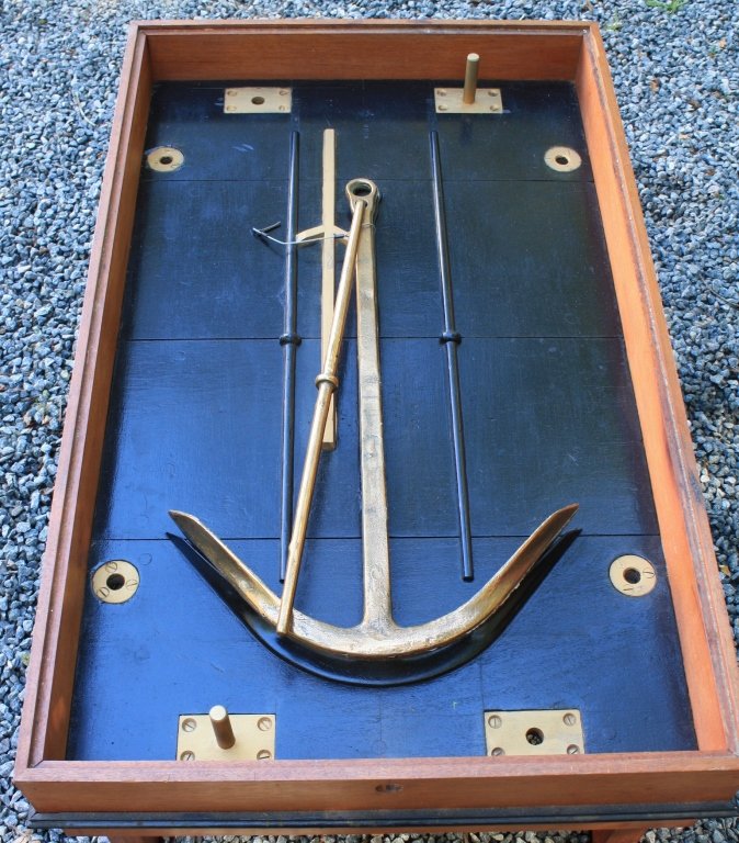 COFFEE TABLE MADE FROM HERRESHOFF FOLDING ANCHOR: BRASS PATENT MODEL AND OLD CASTING FORM, MARKED HM CO. #12599. THE MOLD COMES WITH A BRASS ANCHOR. NATHANAEL GREENE HERRESHOFF 1ST WAS AN AMERICAN NAVAL ARCHITECT AND YACHT DESIGNER. 15" HIGH, 40" LON