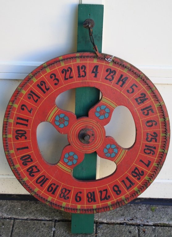 EARLY 20TH C SMALL POLYCHROME PAINTED GAMING: WHEEL. 24" DIAMETER, 34" HIGH. GOOD WORKING CONDITION.