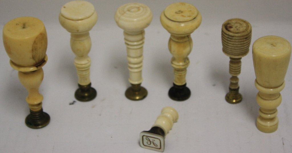 SEVEN 19TH C SCRIMSHAW LETTER SEALS WITH NICELY: TURNED HANDLES, 1 1/2" X 3 5/8" HIGH. THE IPPOLITO COLLECTION.