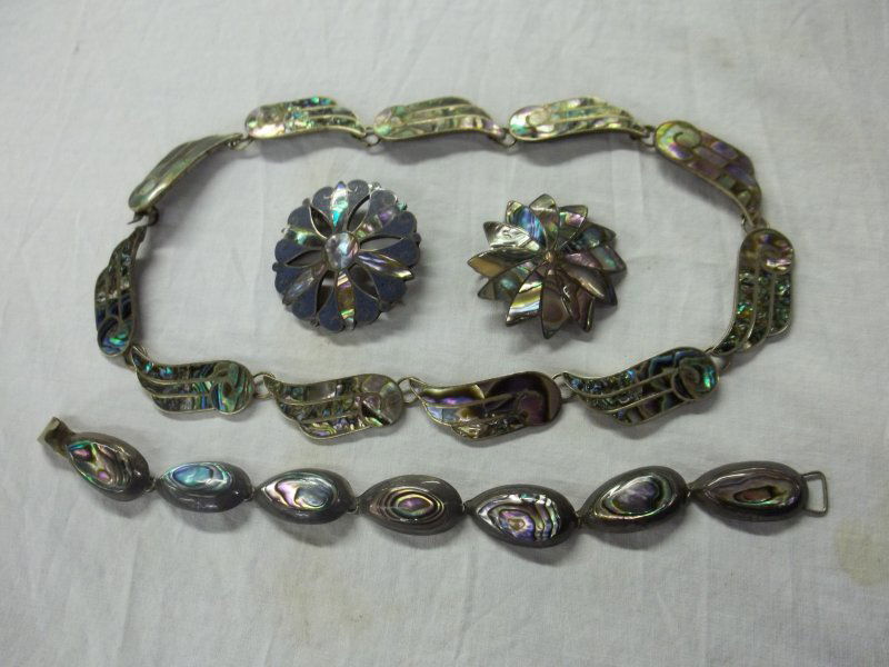4 Pc Mexican Siver jewelry w/ Abalone Inlay: 1 Silver necklace, 1 Silver Bracelet, 2 silver pins.Necklace length 16 1/2 inches. Bracelet length 8 inches, pins 1 1/2 inches round