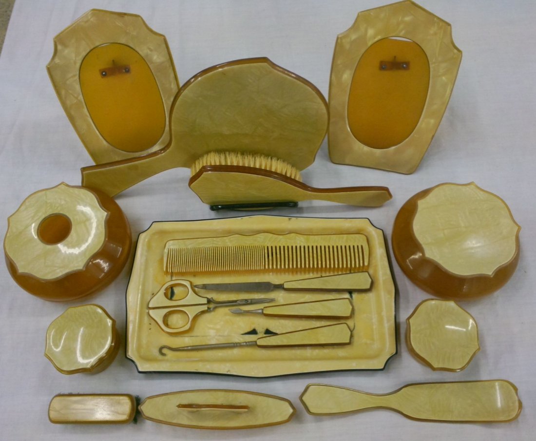 17 pc Celluloid Dresser Set: includes: 2 picture frames, hand mirror, hair brush, comb, hair receiver, powder jar, 2 cold cream jars, nail buffer, shoe horn, small brush, button hook, nail file cuticle tool, scissors & tray