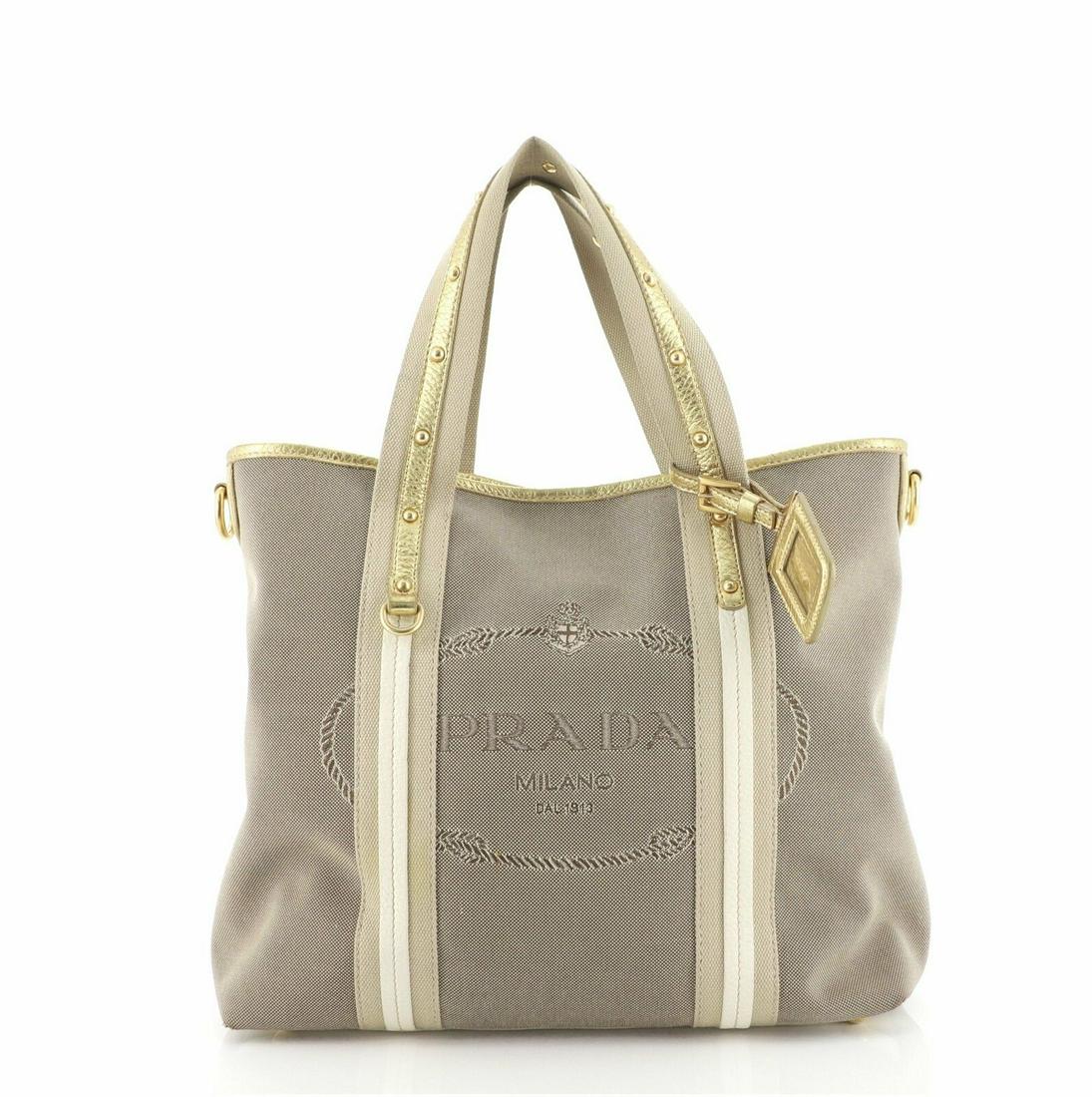 Prada Logo Convertible Tote Canvas with Studded Leather: Prada Logo Convertible Tote Canvas with Studded Leather Large Condition: Pre-owned: An item that has been used or worn previously. . Brand: Prada Color: Neutral Material: Canvas (Plain), Leather Depar