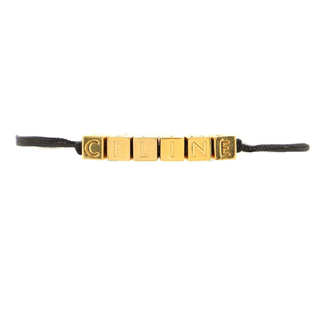 Celine Beach Bracelet Metal with Polyester: Celine Beach Bracelet Metal with Polyester Exterior Color: Black, Gold Collateral: Signed Box Material: Fabric, Metal Item No: 114346/75 Brand Code: UOA0241 SIZE AND FIT: Circumference: