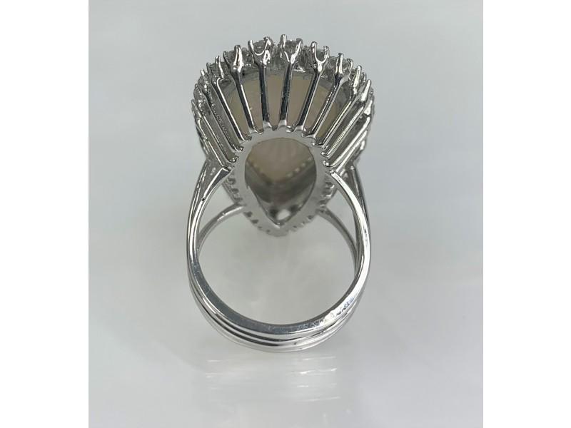 18K White Gold Opal Diamond Ring: 18K White Gold Opal Diamond Ring An eye-catching and luxurious Australian Opal ring boasting an elongated pear shaped center stone weighing 10.05 carats surrounded by a vintage halo of diamonds weighi