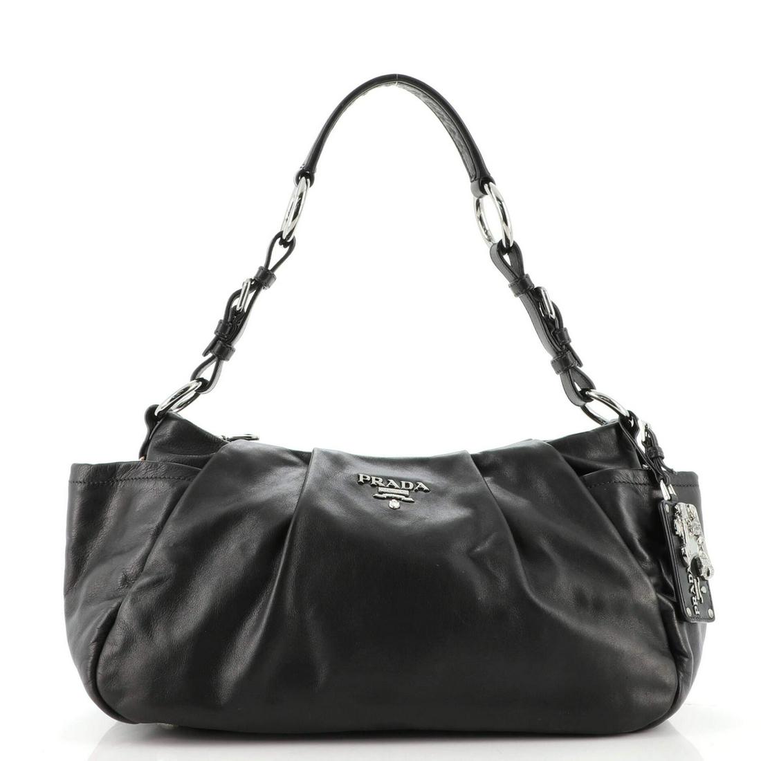 Prada Side Pocket Hobo Soft Calf Medium: Prada Side Pocket Hobo Soft Calf Medium Exterior Color: Black Interior Color: Black Exterior Material: Leather Interior Material: Fabric Hardware Color: Silver Accessories: Charms, Dust bag