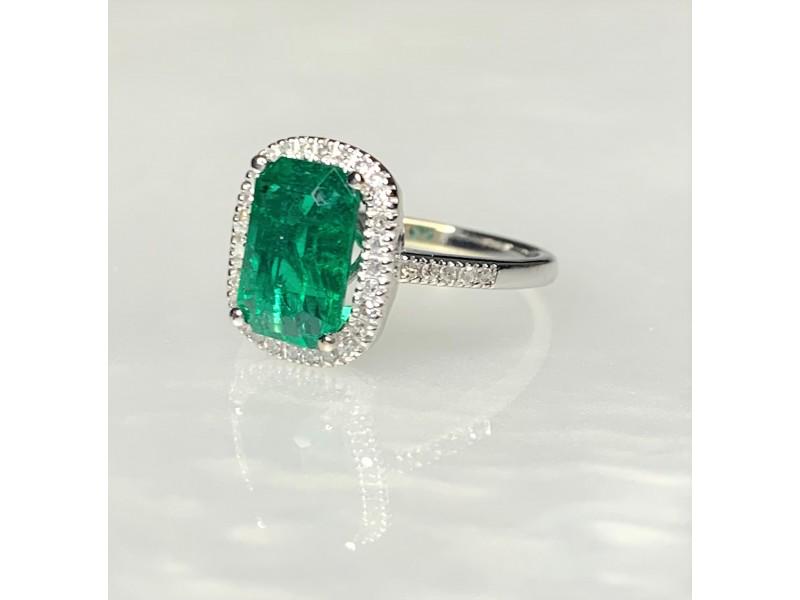 14K White Gold Emerald Cut Emerald Diamond Ring: 14K White Gold Emerald Cut Emerald Diamond Ring Product Code: 14KWHITEGO-62017B617ABA0 Condition: Never Worn ---- A graceful and timeless emerald ring featuring a vibrant deep green emerald cut center