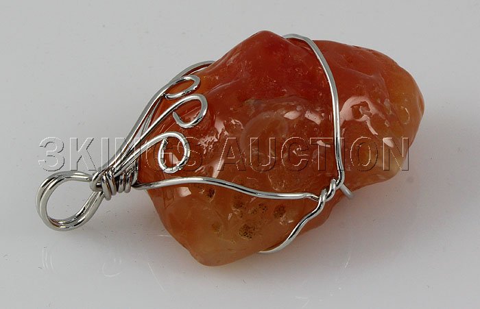 Natural 101.75ctw Uncut Carnelian Silver Pendant: Natural 101.75ctw Uncut Carnelian Silver Pendant **|**|** Tumbled Rough Carnelian Stone Wrapped with Sterling Silver Wire size: 36.56x24.22x15.89mm; color: Orange; stone: Uncut Gemstone ; MSRP: $300
