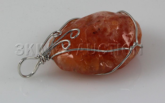 Natural 119.80ctw Uncut Carnelian Silver Pendant: Natural 119.80ctw Uncut Carnelian Silver Pendant **|**|** Tumbled Rough Carnelian Stone Wrapped with Sterling Silver Wire size: 37.80x33.25x16.44mm; color: Orange; stone: Uncut Gemstone ; MSRP: $300