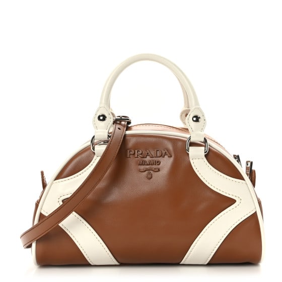 Prada Soft Calfskin Bowling Crossbody: Prada Soft Calfskin Bowling Crossbody Bag Cognac White SKU no: RBJ1417577 Brand: PRADA Condition: Excellent Condition Details: Exterior: Scuffs, edge wear, Hardware: Faint scratch(es) Base length: 9 i