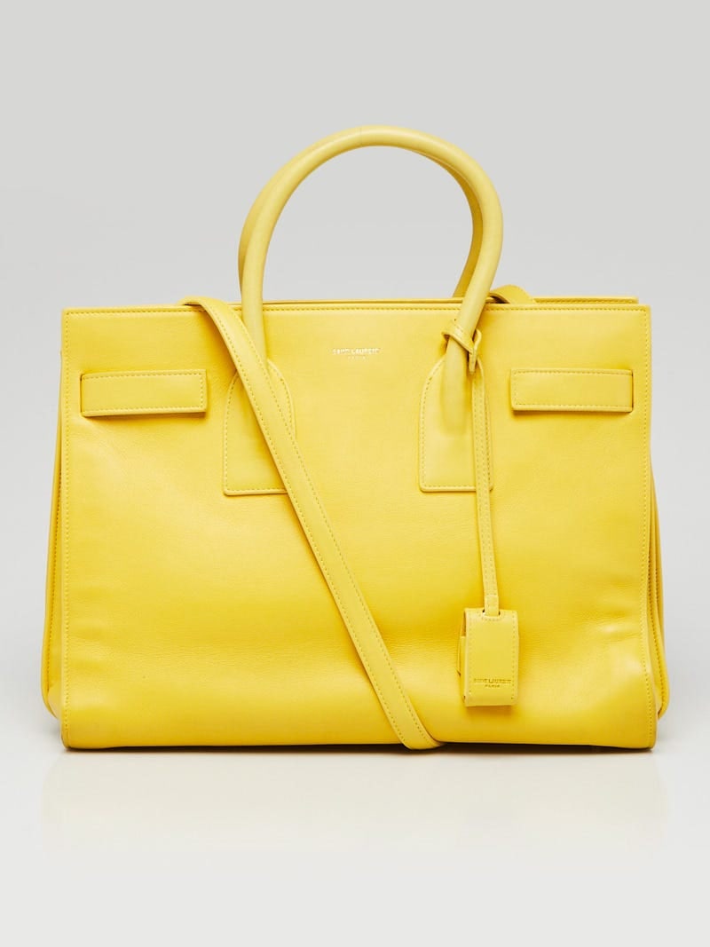 Yves Saint Laurent Yellow: Yves Saint Laurent Yellow Calfskin Leather Small Sac de Jour Tote Bag Overall Condition: Gently used Exterior Condition: Gently used Interior Condition: Gently used Designer: Yves Saint Laurent Materi