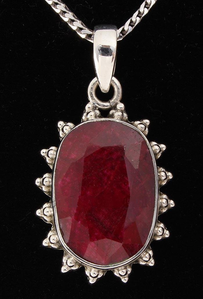RUBY CORRUNDUM 34.61CTW STERLING SILVER PENDANT: RUBY CORRUNDUM 34.61CTW STERLING SILVER PENDANT **|**|** 20X13MM OVAL SHAPE RUBY CORRUNDUM FLOWER DESIGN SILVER PENDANT ; MSRP: $400