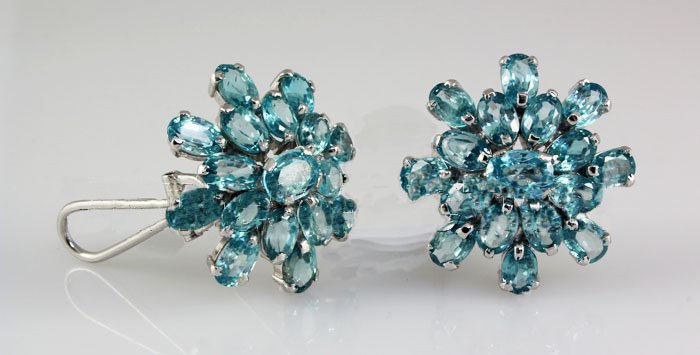 60.05CTW Flower Blue Zircon Cluster Silver Earring: 60.05CTW Flower Blue Zircon Cluster Silver Earring **|**|** Sky Blue Zircon Gemstone in Flower Design Silver Earring w/ Clipon Back; small 6x4mm*center 7x5mm; ctw: 26.90; stone count: 34; gram weight: