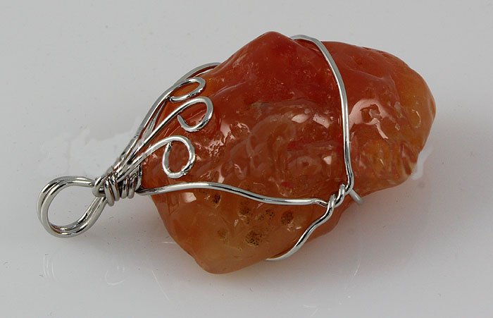Natural 101.75ctw Uncut Carnelian Silver Pendant: Tumbled Rough Carnelian Stone Wrapped with Sterling Silver Wire size: 36.56x24.22x15.89mm; color: Orange; stone: Uncut Gemstone