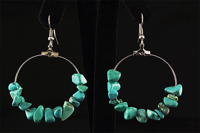NATURAL 37.71CTW TURQUOISE HOOP SILVER HEARRING: NATURAL 37.71CTW TURQUOISE HOOP SILVER HEARRING **|**|** 2.38X1.55 IN DIAMETER HOOP EARRING WITH CHIPS BLUE TURQUOISE GEMSTONE ; MSRP: $100