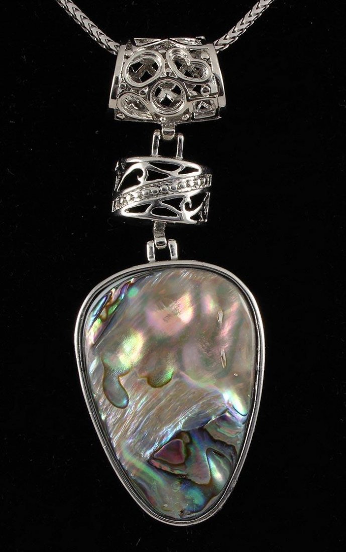 NATURAL 15.03GRAMS MOTHER OF PEARL SILVER PENDANT: NATURAL 15.03GRAMS MOTHER OF PEARL SILVER PENDANT **|**|** 1.50X1.08 INCHES PEAR SHAPE MOONSTONE RAINBOW COLOR MOTHER OF PEARL SILVER PENDANT ; MSRP: $300