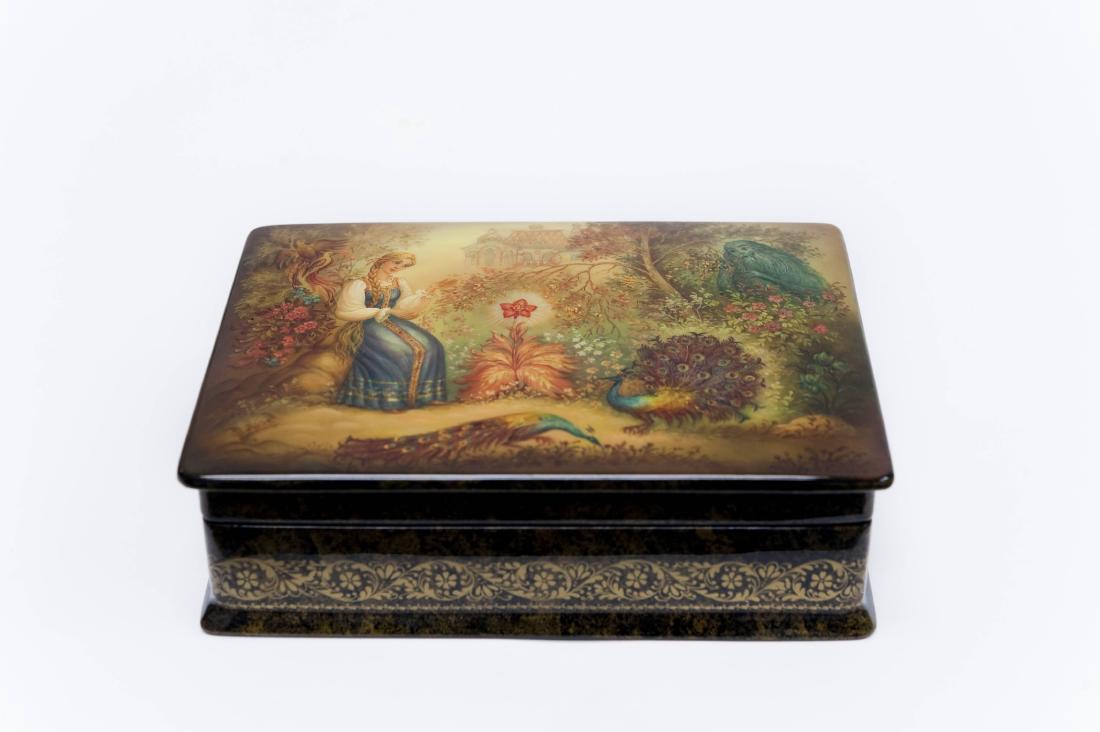 Balabinova Fedoskino Russian Lacquer Box.: Balabinova Fedoskino Russian lacquer box. Rectangular box with hinged lid depicting a young woman in the garden with crimson flower and peacocks. Signed. Gilt decoration on all sides. (Approx. 1 3/4" 
