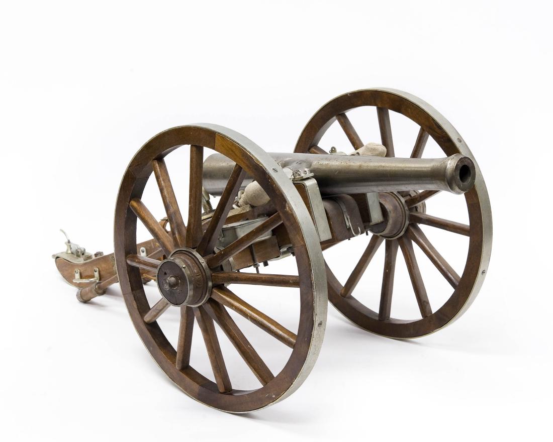 Hand Crafted Model Cannon.: Hand crafted model cannon. Cast metal barrel flanked by two hinged supply boxes and two long loading and cleaning ramrods, on wooden gun carriage. (Approx. 11 1/2" tall, 25 1/2" x 14").