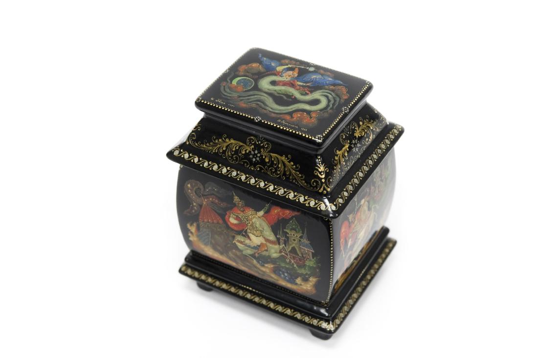 Paramonov Palekh Russian Lacquer Box.: Paramonov Palekh Russian lacquer box. Rectangular casket form small box with the removable lid and 4 sides depicting a fairy tale of Ruslan & Ludmila. Marked Palekh 1750, signed, dated 1993. Made in R