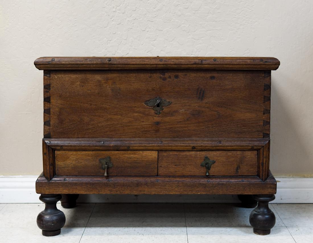 Early American Miniature Mahogany Blanket Chest.: Early American miniature Mahogany Blanket Chest. Diminutive mahogany coffer fitted with two lower drawers. Iron strap work hinged lid and lock, the dovetailed case on ball feet. Circa 1800. (20" tall,