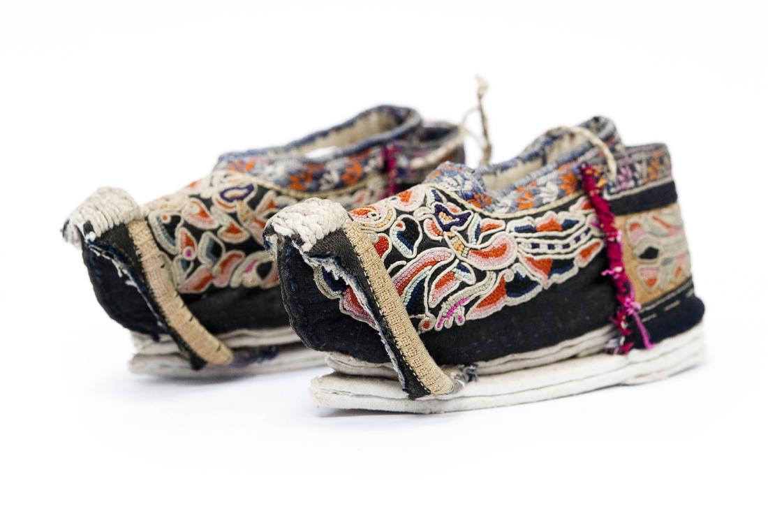 Pair of Late 19th C. Chinese Lotus Shoes.: Pair of late 19th C. Chinese lotus shoes. Hunan province. Yellow silk embroidery with peking knot, phoenixes and dogs. (2 1/2" x 5").