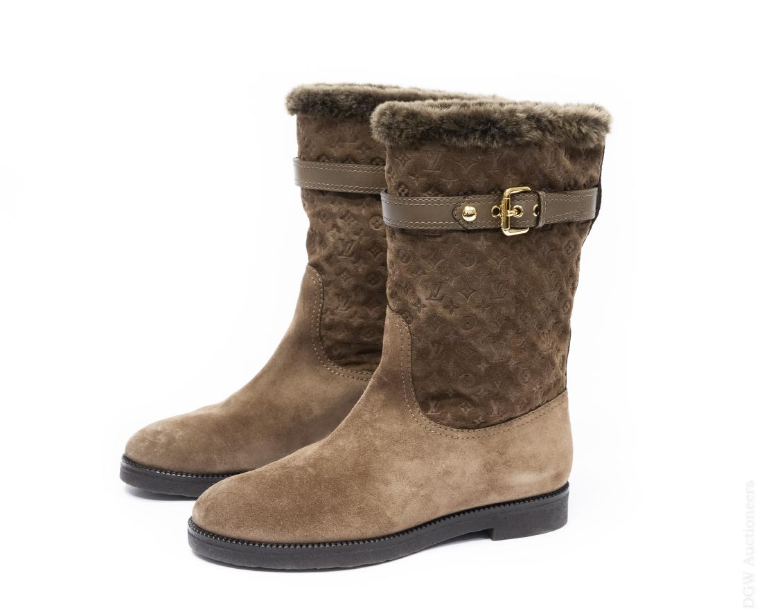 Pair of Louis Vuitton Boots.: Pair of lady's Louis Vuitton high taupe suede and fully fur-lined boots with leather and gold buckle accents. Rubber soles. (XTYR 1BSC07N380). Assumed size 38. With two protective cloth bags and origi