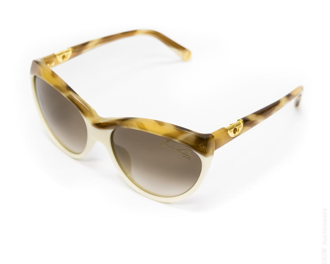 Pair of Louis Vuitton Sunglasses.: Pair of Louis Vuitton sunglasses. Hand made in Italy. Lunettes de Soleil. With conforming chain. E0190 / Z0353E. With case, LV box and LV brochure.