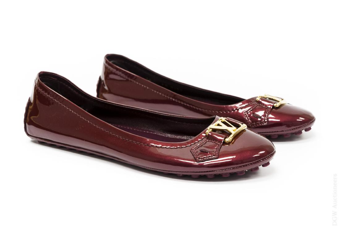 Louis Vuitton Oxford Flat Ballerina Shoes.: Louis Vuitton Oxford Flat Ballerina shoes. Burgundy leather with gold colored metal LV monogram. Size 38, Made in Italy. FA0130. With protective bags and box.