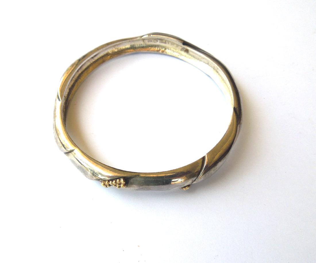 Georg Jensen No. 332 B Sterling Silver Bangle Bracelet.: Georg Jensen sterling silver bangle bracelet with yellow gold bead decoration, designer Ole Kortzau. Hallmarked: Georg Jensen 925s Denmark 332B OK. (1.82 troy oz).