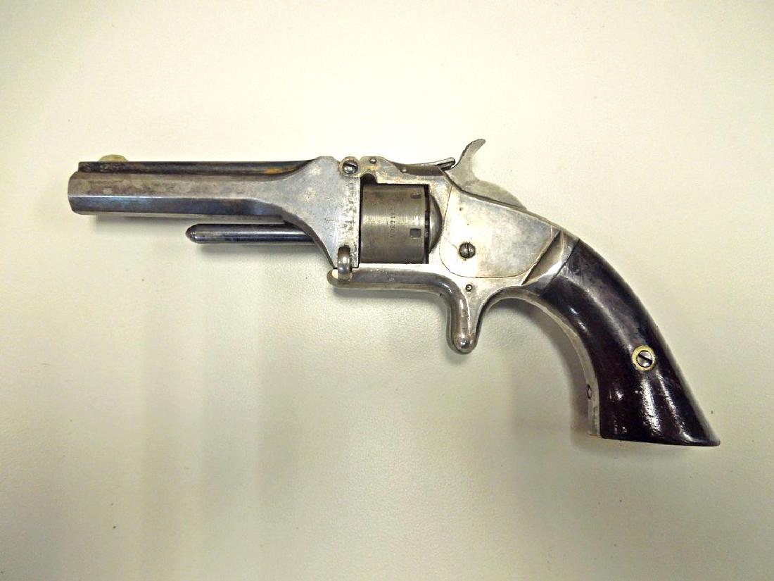Antique Smith & Wesson Model 1 Revolver.: Antique Smith & Wesson Model 1 (second issue) single action spur trigger tip-up seven shot revolver. Caliber .22SR, serial number 99953, barrel length 3-3/16 inches.
