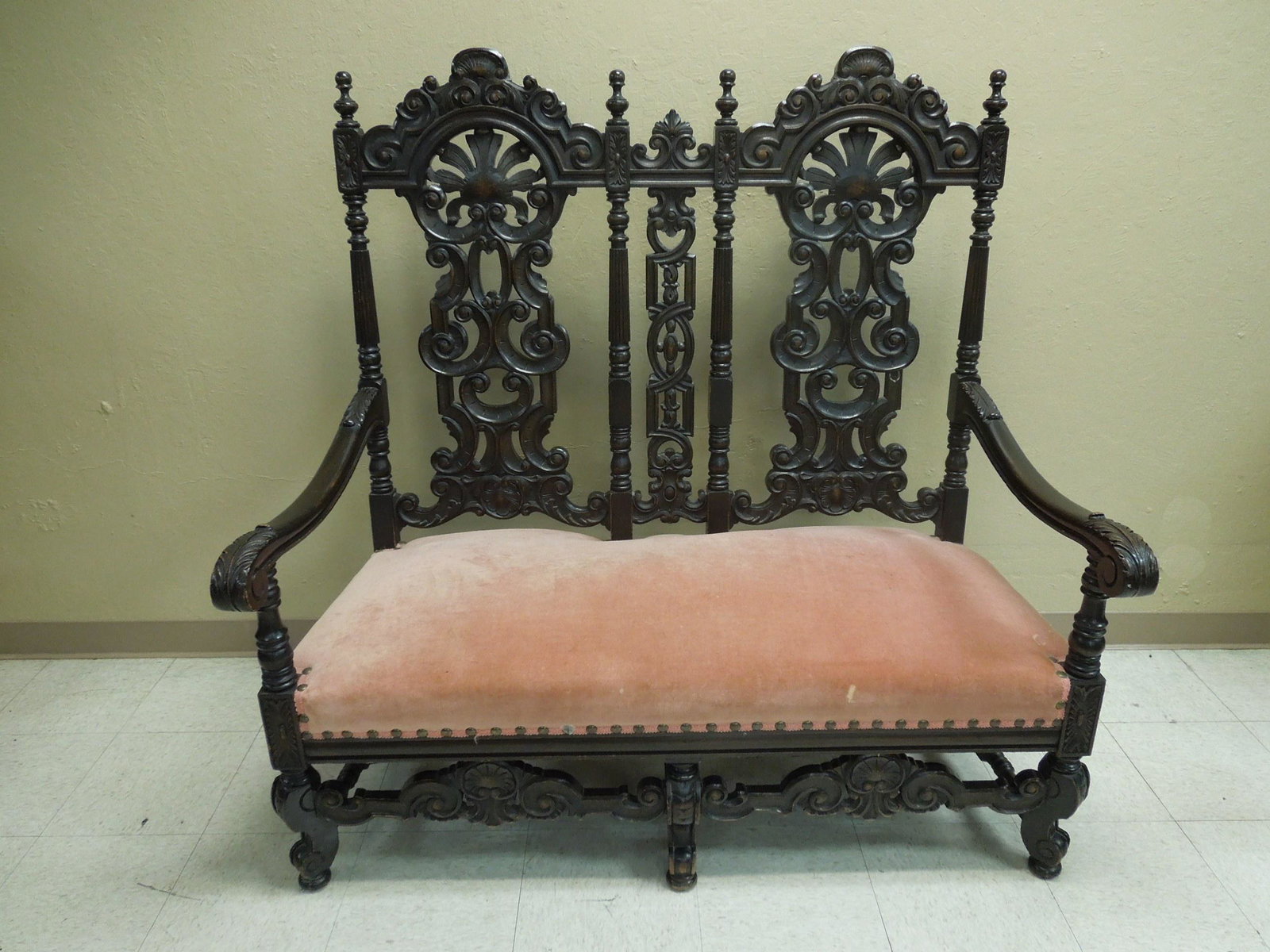 Spanish Baroque High Back Settee.: Spanish Baroque two seat high back settee. Finialled acanthine and shell carved crest rail, openwork splats centered by turned and reeded supports, with conforming seat rail. Scroll arms and dusty ros