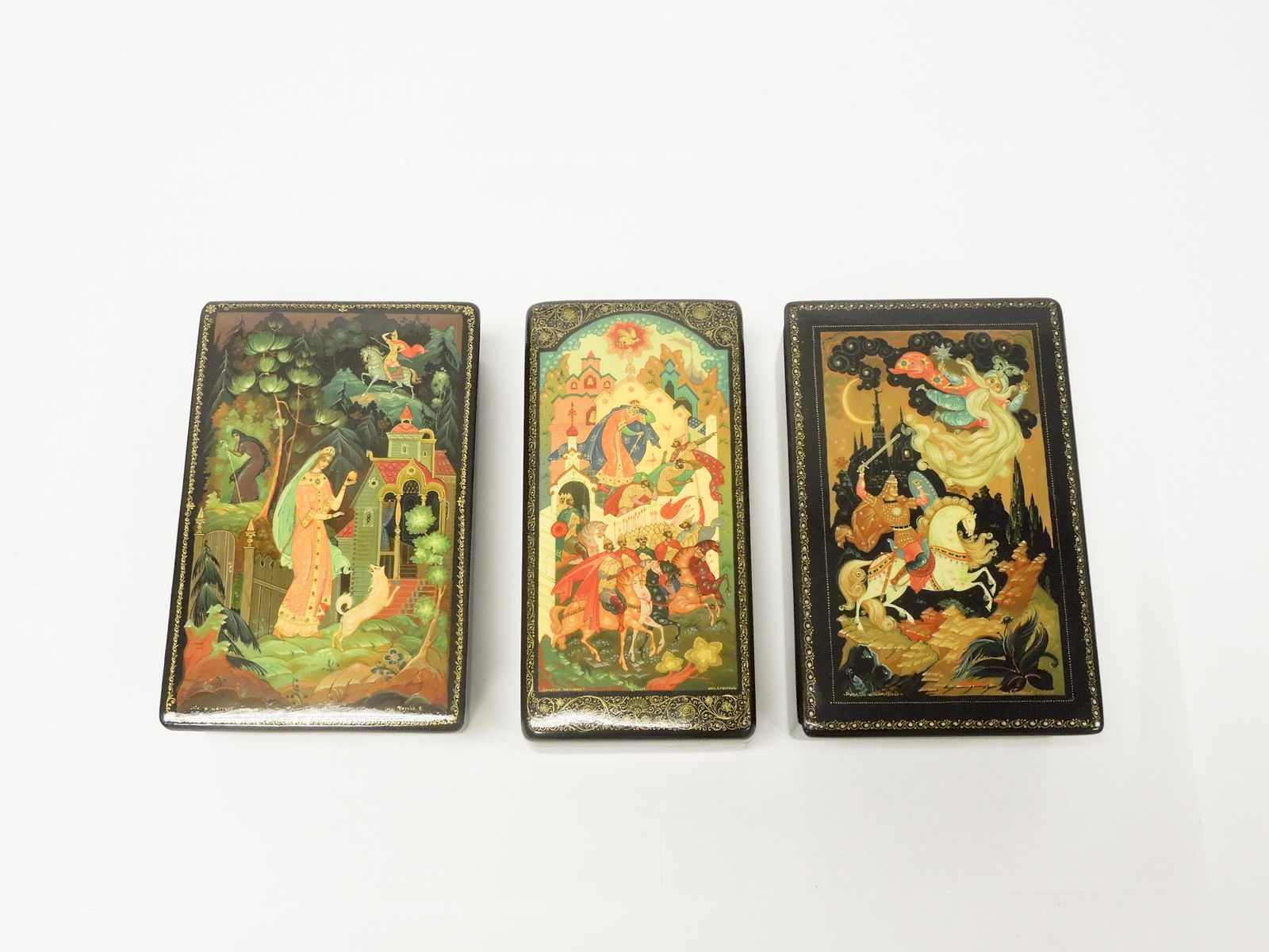(3) Kholui Russian Lacquer Boxes.: (3) Kholui Russian lacquer boxes. Signed and titled. (6 1/4 x 4, 6 1/2 x 3 1/2 & 6 1/4 x 4 inches).