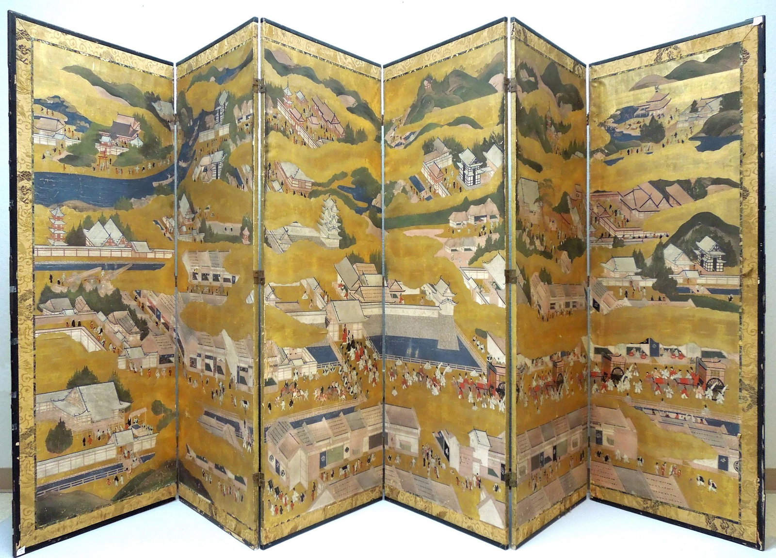 Meiji Period Japanese Six Panel Screen.: Japanese six panel screen, Meiji period. (Rakuchu rakugai zu). Large six panel folding screen, ink, color and gold on paper; featuring scenes in and around Kyoto, the various vignettes of life in the 