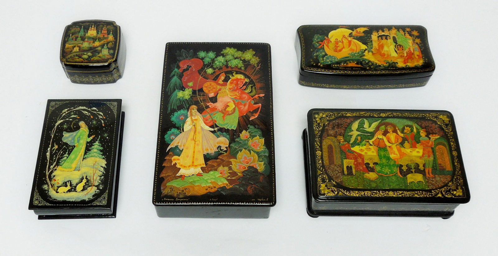 (5) Kholui Russian Lacquer Boxes.: (5) Kholui Russian lacquer boxes. (4) Rectangular hinge lidded boxes and a square removable lid box. Signed and titled. (8 x 4 3/4 x 7/8 to 2 3/4 x 2 3''4 x 1 1/2 inches).