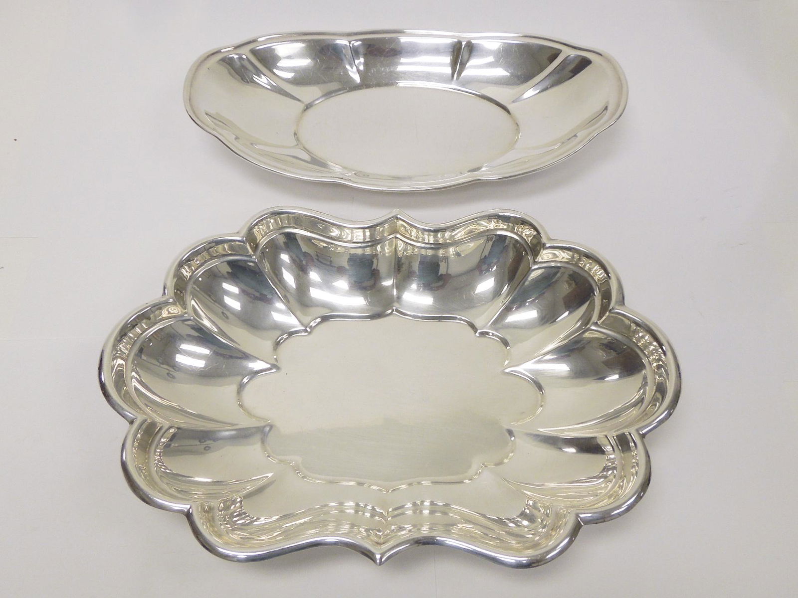 (2) Sterling Silver Bread Bowls.: (2) Sterling Silver Bread bowls. Reed & Barton scalloped bowl, "Windsor" pattern and one marked Sterling. (12 1/4 & 8 5/8 inches long, 25.85 troy oz).