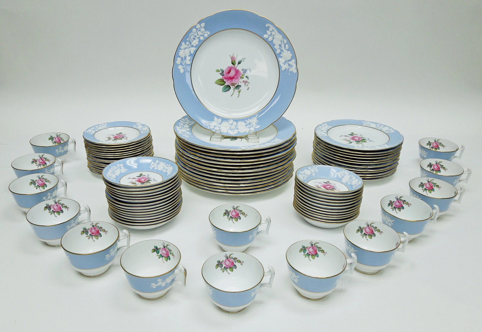 Spode Maritime Rose Porcelain Dinner Service.: Spode Maritime Rose porcelain dinner service., 83 pieces. 15 Dinner plates (10 3/4"), 12 Salad plates (8 1/8"), 15 Bread & Butter plates (6 1/4"), 12 Dessert bowls (5 1/8"), 15 Saucers and 14 Cups.