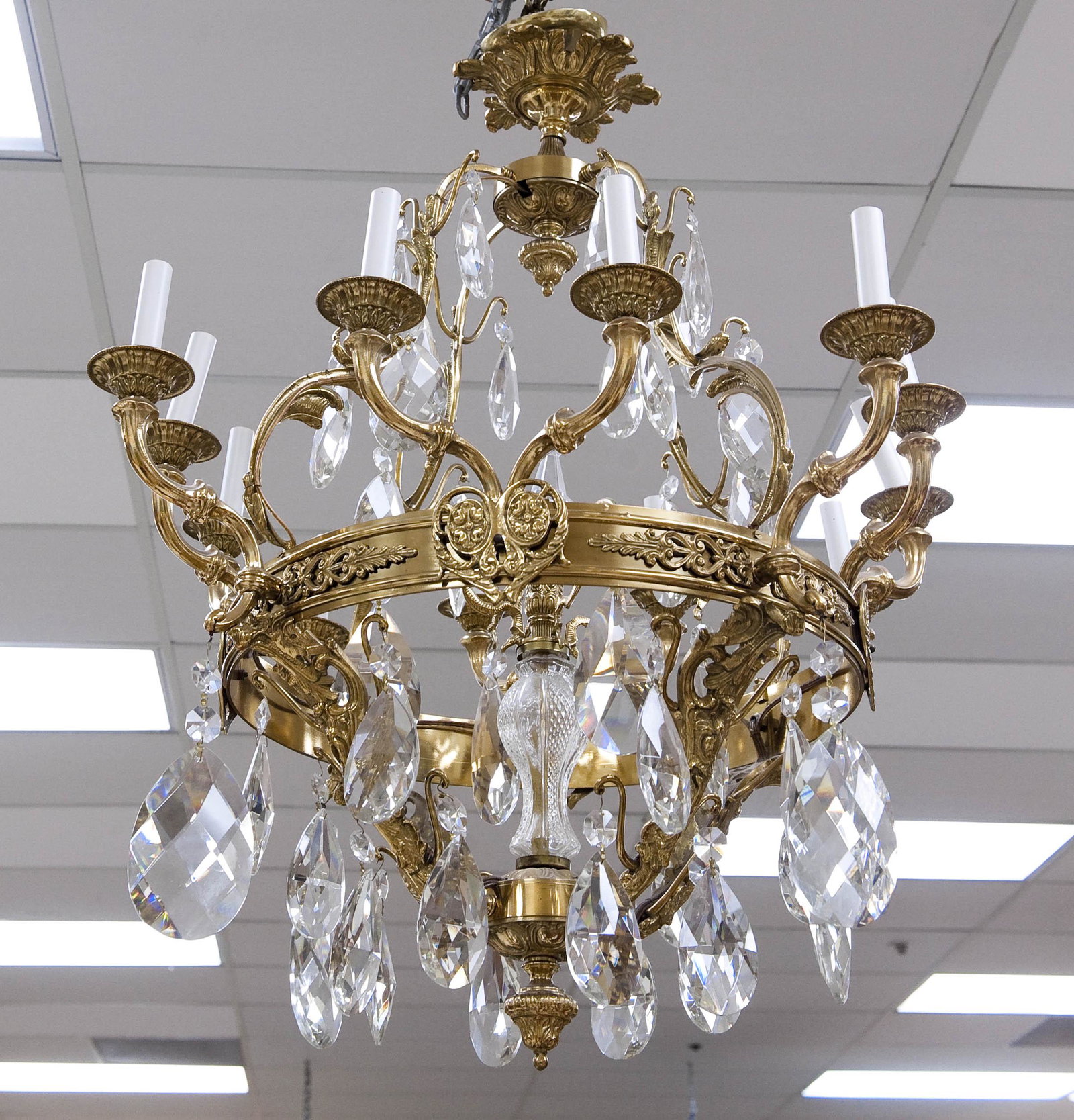 Large Baroque Style Gilt Metal Chandelier.: Large Baroque style gilt metal, 12-light chandelier. The frame with acanthine and scroll decoration. Tear drop crystals and candlestick form lights.
