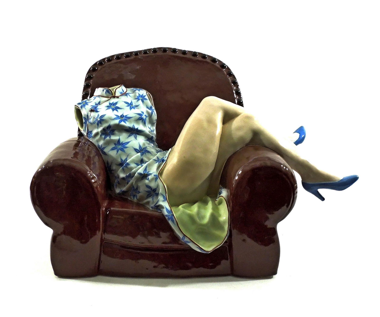 Liu Jianhua Ceramic Sculpture.: Liu Jianhua (Chinese, b. 1962), Obsessive Memories series, contemporary ceramic sculpture modeled as a headless and armless woman wearing a blue and white cheongsam dress lounging in a brown leather c