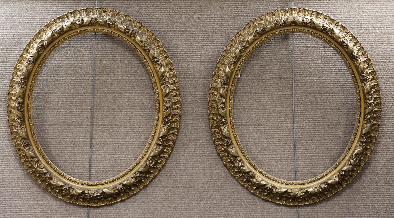 Pair Of Antique Rococo Style Picture/Mirror Frames.: Pair of late 19th/early 20th century rococo style oval carved gilt wood picture/mirror frames with C-scroll and foliate molded decoration in high relief. Label verso reads in part "Jones, Wooll & Suth