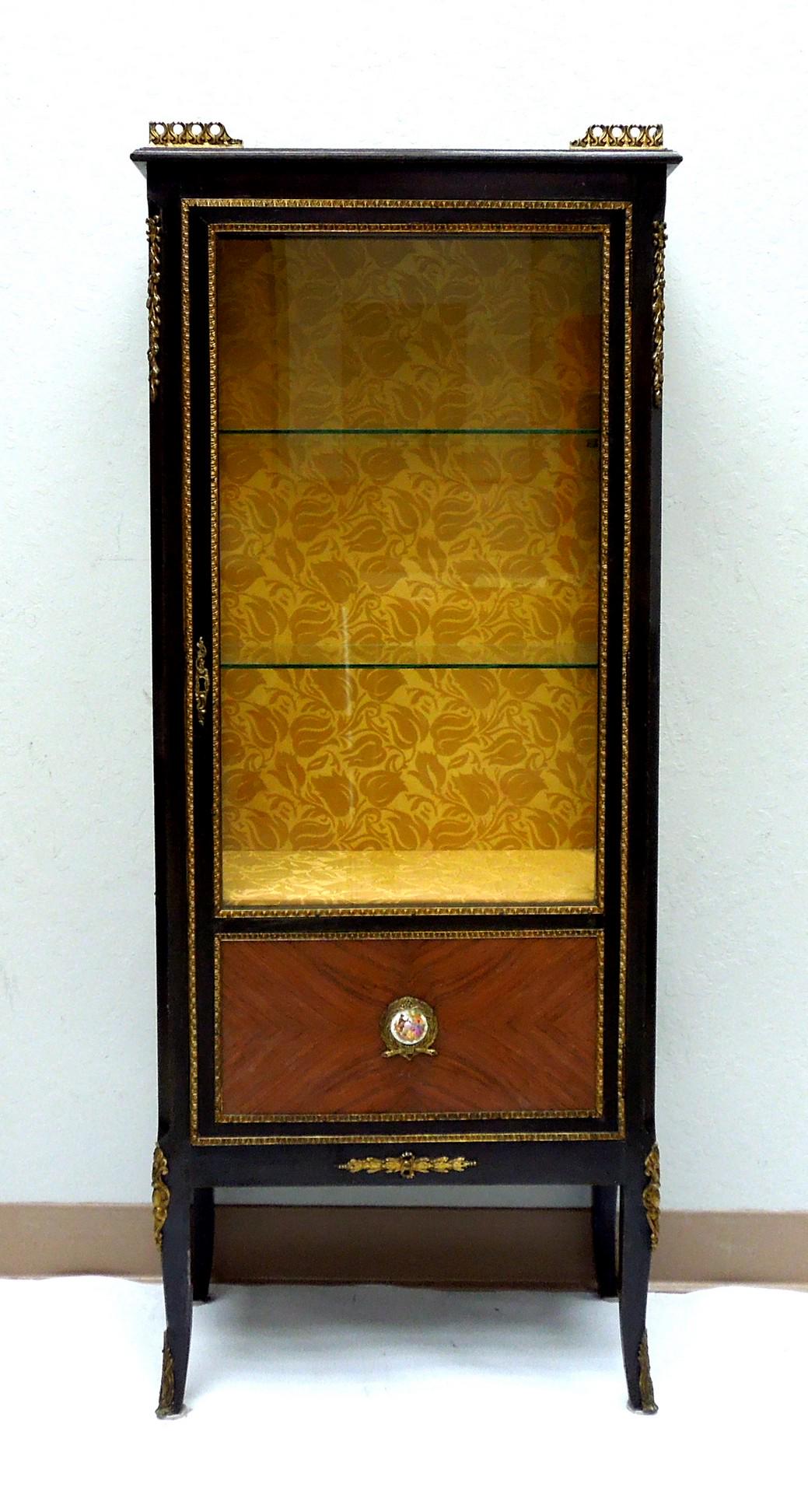 French Regency Style Rosewood Vitrine.: French Regency style rosewood vitrine with walnut inlay, ormolu embellishment and painted porcelain medallion. (53.5" H, 22" L, 12" D).
