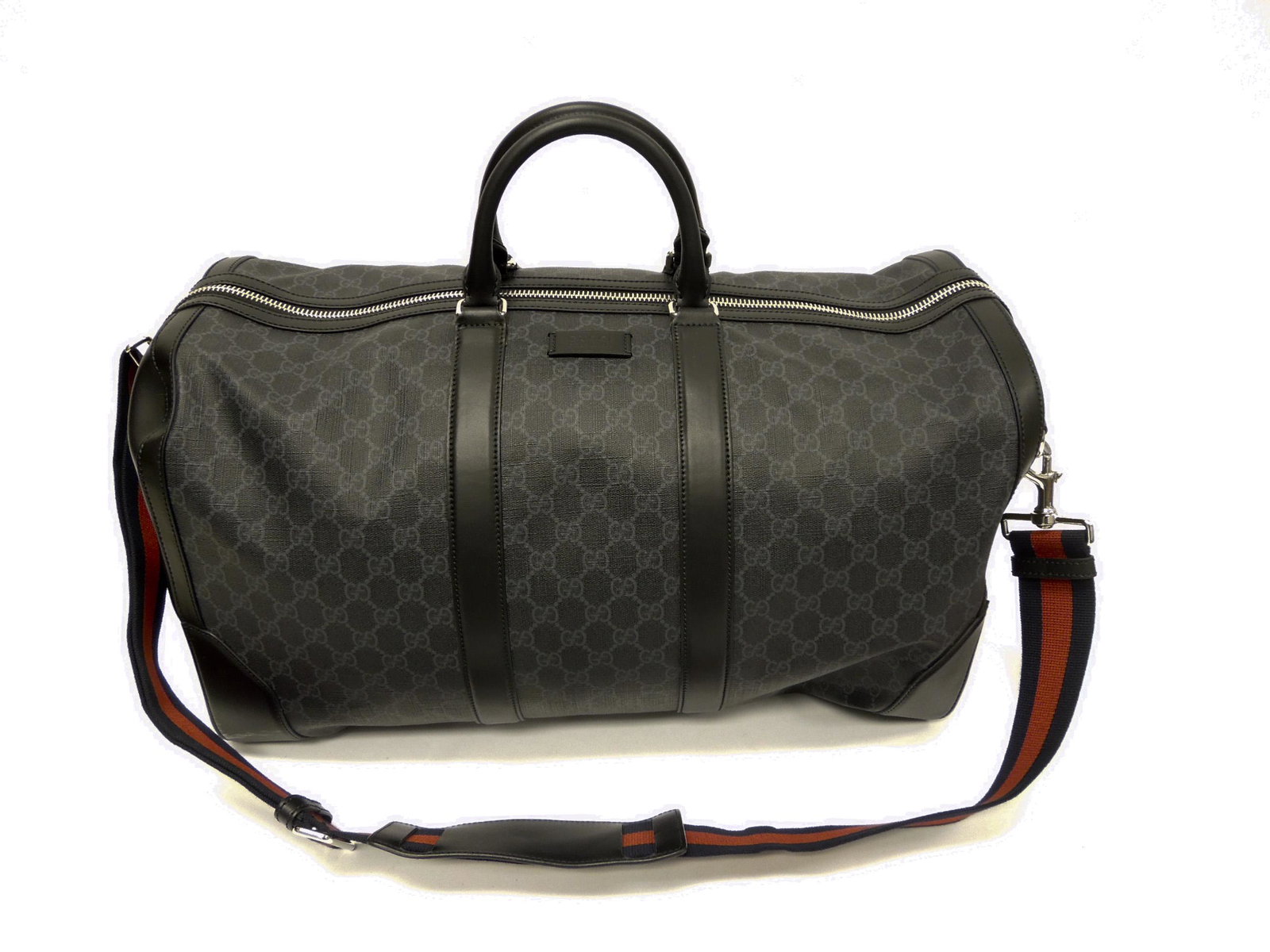 Gucci GG Supreme Carry-on Duffel Bag.: Gucci GG Supreme carry-on duffel bag, Style 478323 with tag, lock and keys. Black canvas interior with zipper pouch on one side and a pocket on the other..