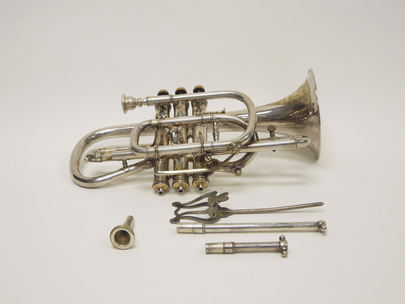 C. G. Conn Wonder Solo Cornet.: C. G. Conn Wonder Solo cornet. Elkhart, Worcester, Mass. Extensive floral engraving. S/N: 30931. With original case.