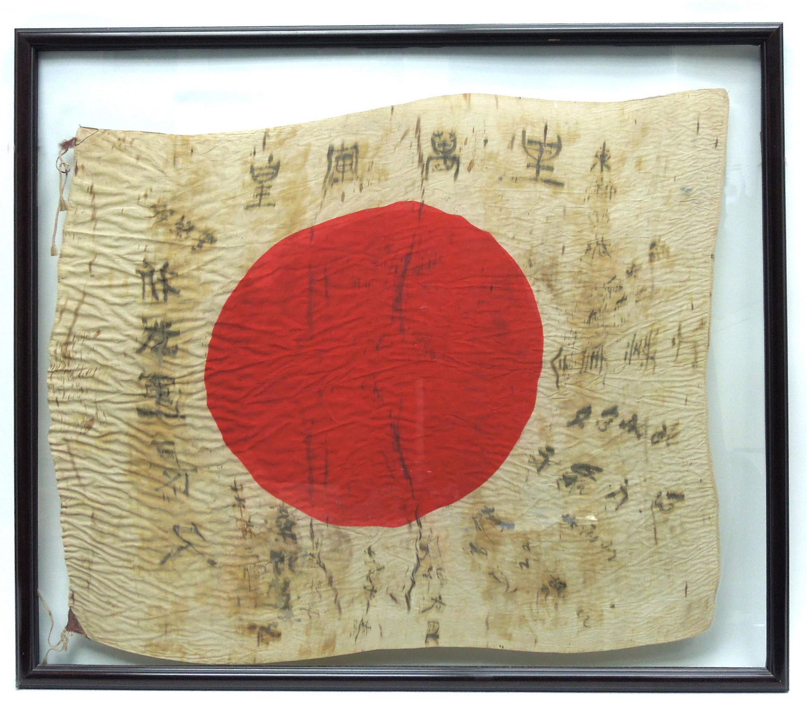 Imperial Japanese Flag with Character Marks.: Imperial Japanese flag with character marks. 27 1/2" x 33 1/2". Framed, under glass. Most likely a Good Luck flag signed by friends and family or soldiers.