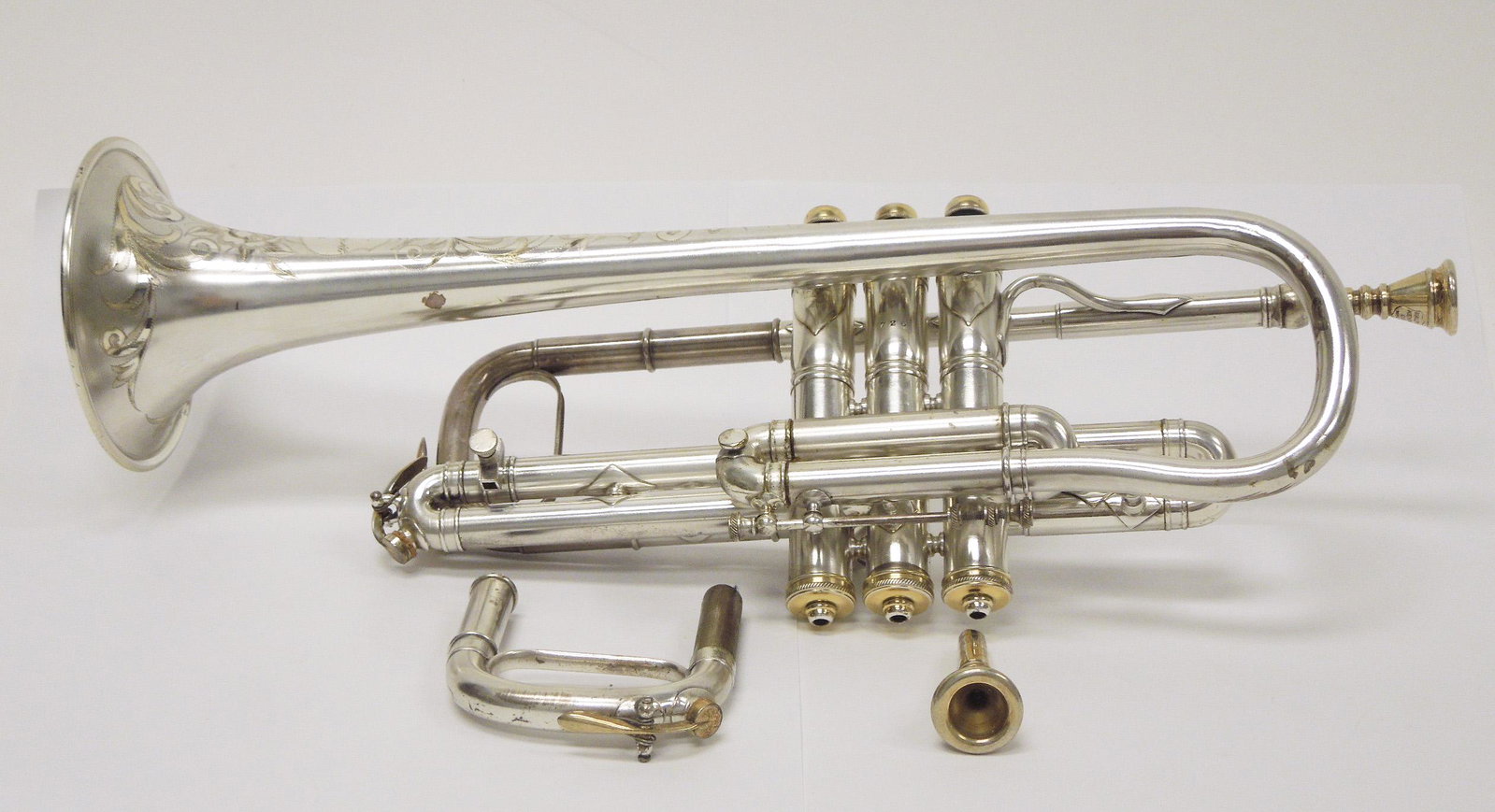 Ralph Kenny Bb Trumpet #726.: Ralph Kenny Bb Trumpet, #926. Silver plated with extensive floral engraving. With 2 mouthpieces and additional slide. First quarter 20th C. With case.
