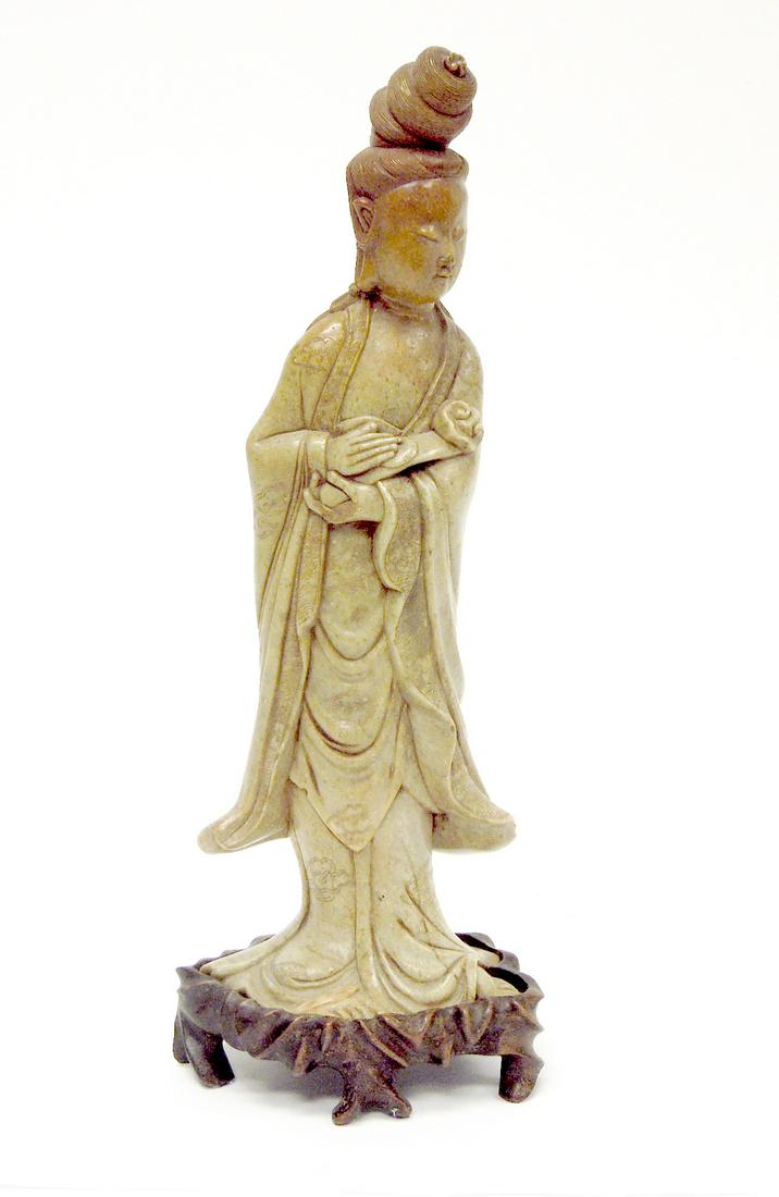 Chinese Soapstone Figure of Guan Yin.: Chinese soapstone figure of Guan Yin on a fitted a stand. Finely carve figure in steatite holding a Chinese symbol of rank. 16" tall overall.