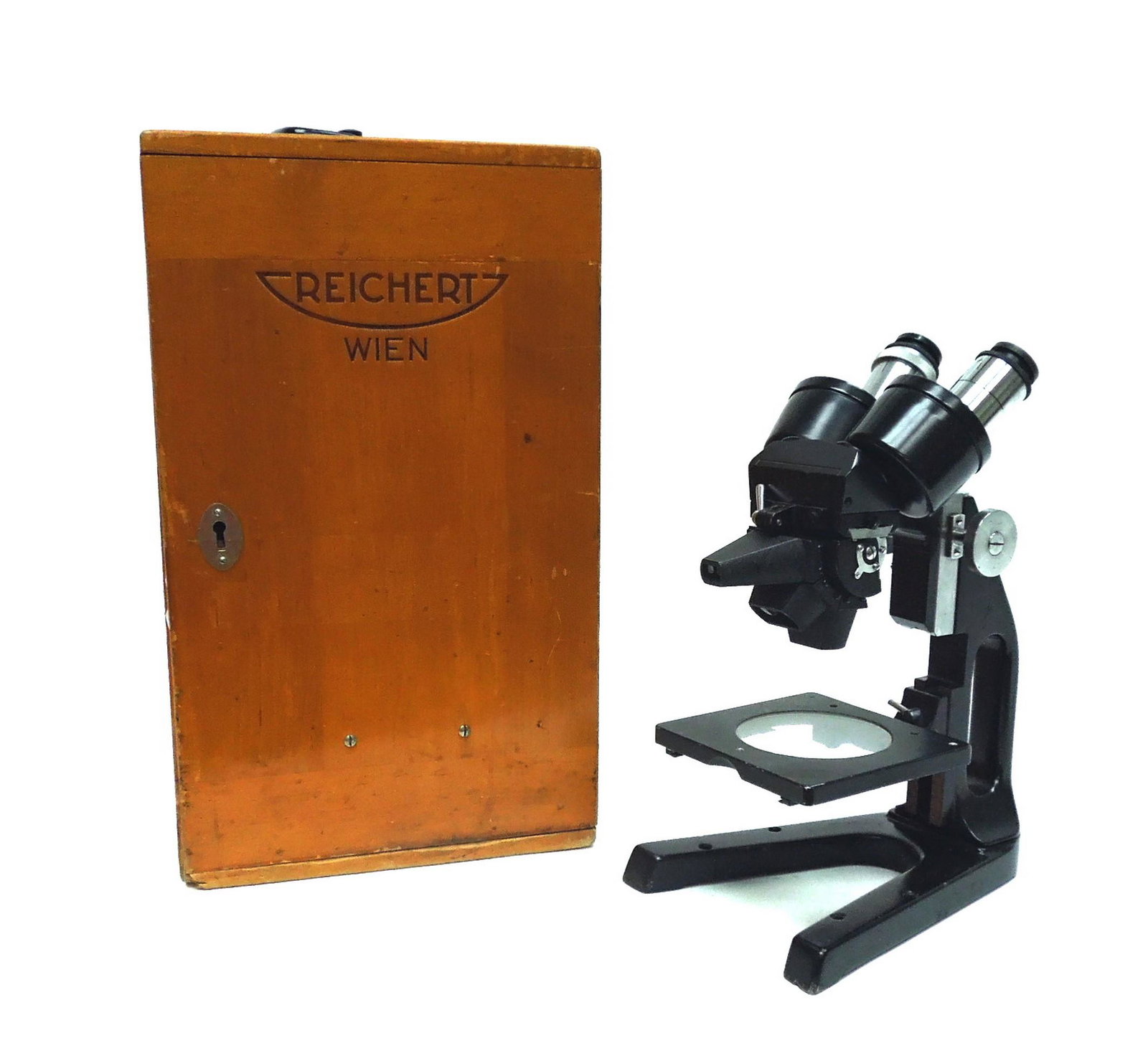 Late 20th C. Reichert Stereo Microscope.: Late 20th C. Reichert laboratory microscope with case. Cast iron base with 3 objective lenses and detachable hand rest wings. No. 220644. Approximately 12" long.