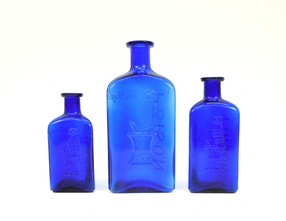 (3) Owl Drug Company Cobalt Blue Triangular Bottles.: Group of (3) Owl Drug Company triangular Cobalt blue single wing embossed apothecary bottles. 7 3/4", 6" & 5 1/4" tall.