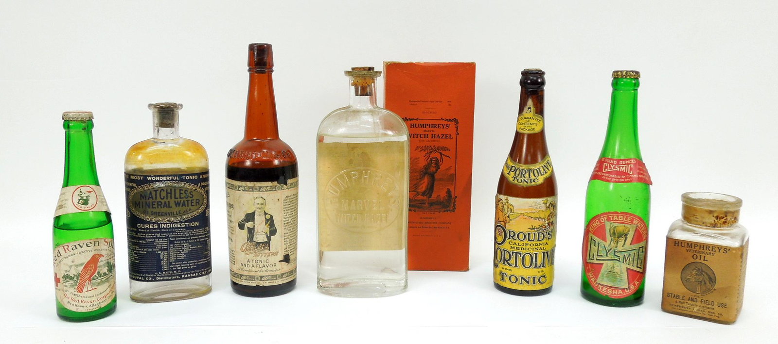 Group of Antique Mineral & Medicinal Tonics.: Group of antique mineral and medicinal tonics and liquids with stoppers, corks and original labels. Includes Humphrey's Marvel Witch Hazel with box., Prouds California Portolive tonic.