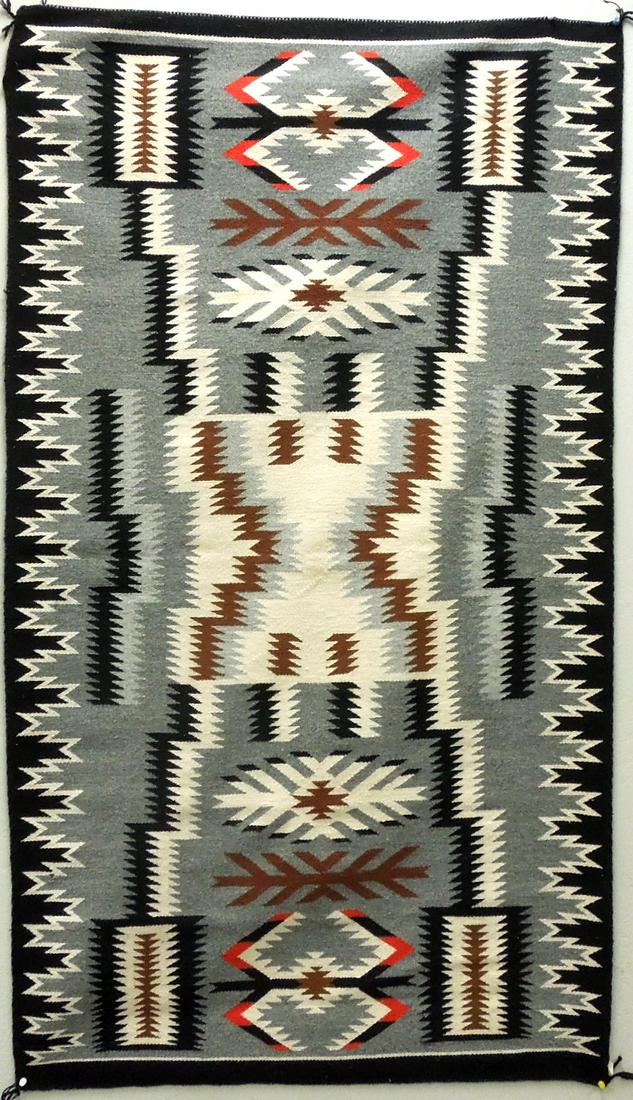 Navajo Handwoven Storm Pattern Rug.: Navajo hand woven Storm pattern rug in black, white, grey, brown and red. 63" x 35.5".